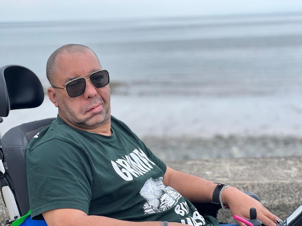 Chris Lucas in his wheelchair beside the sea